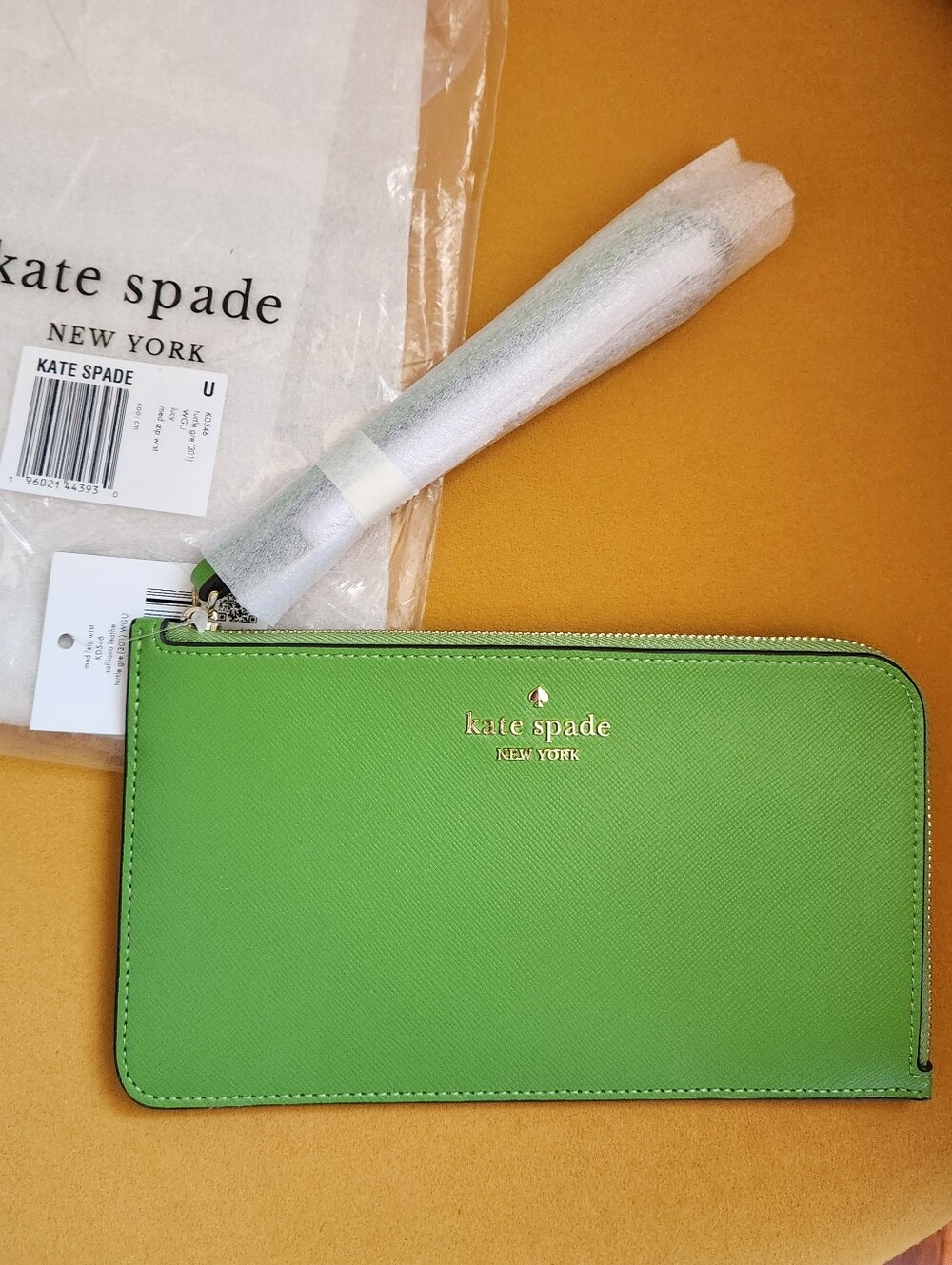 Kate Spade bright green saffiano wristlet with gold logo